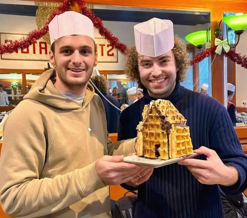 Two happy participants showing off a waffle house creation at our Ghent workshop
