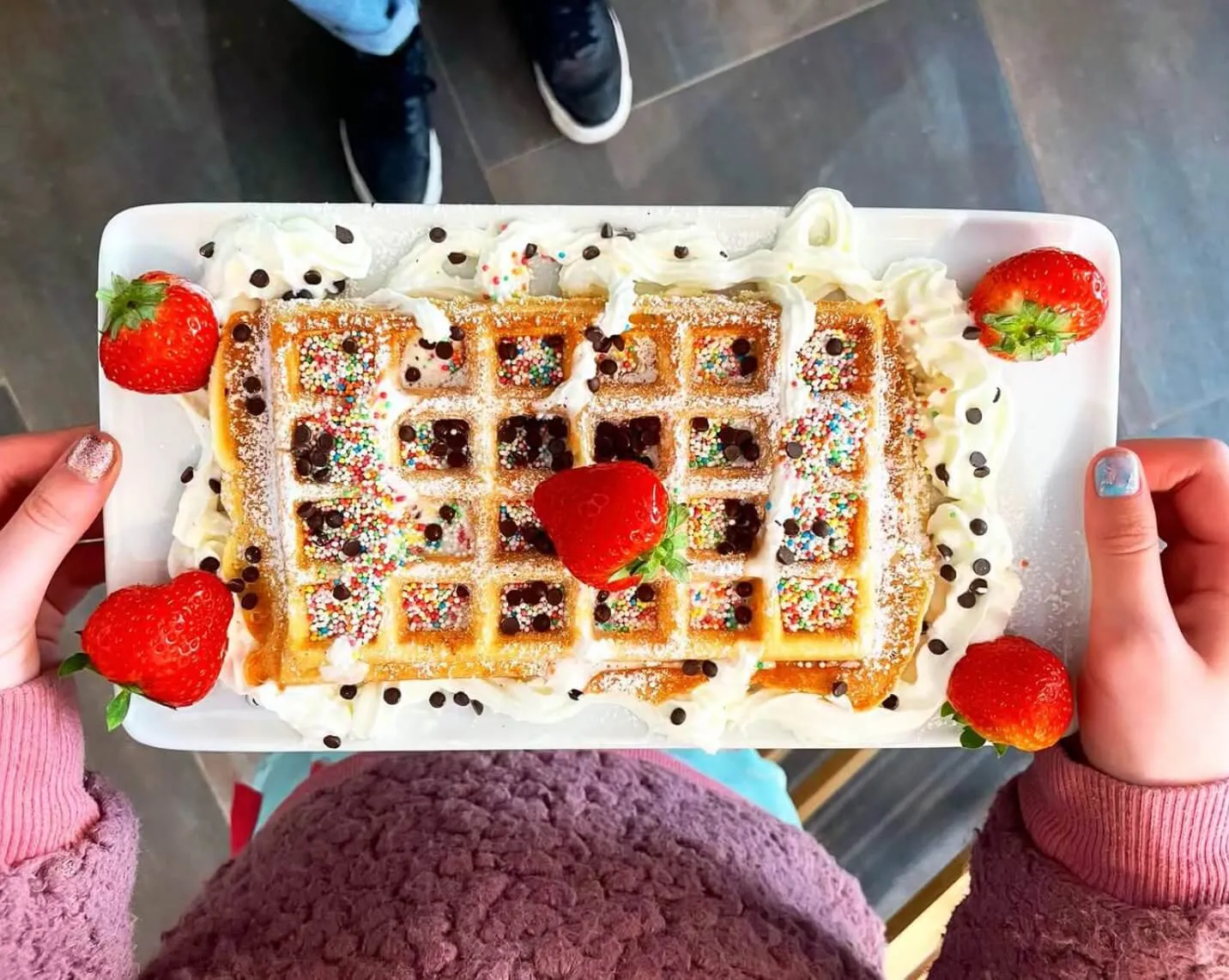 Top rated waffle activity in Ghent - decorated waffle with strawberries and sprinkles